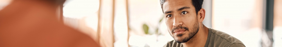 A man receives counseling services in an office setting.