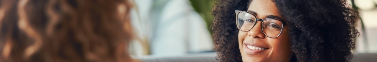 A woman provides support during a motivational interviewing conversation conducted in an office setting.