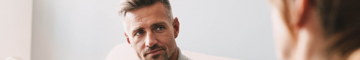 A man receives counseling in an office setting.